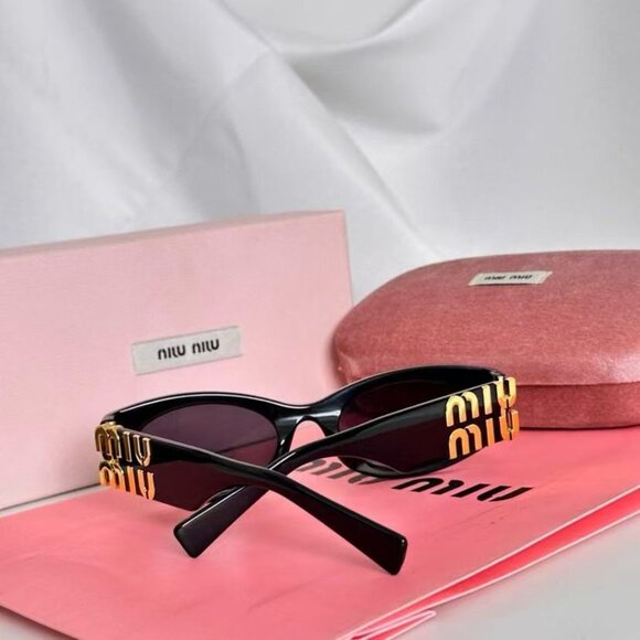 Miu Miu black sunglasses featuring elegant gold accents main image 7